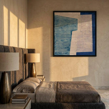 Canvas wall art with a black surround styled on the wall in a luxe bedroom