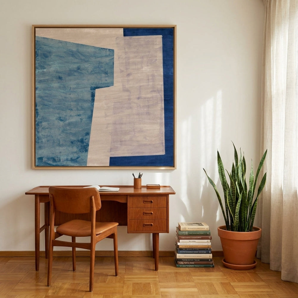 Oversized statement canvas wall art with a natural timber surround styled on the wall in a mid-century home office