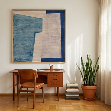 Oversized statement canvas wall art with a natural timber surround styled on the wall in a mid-century home office