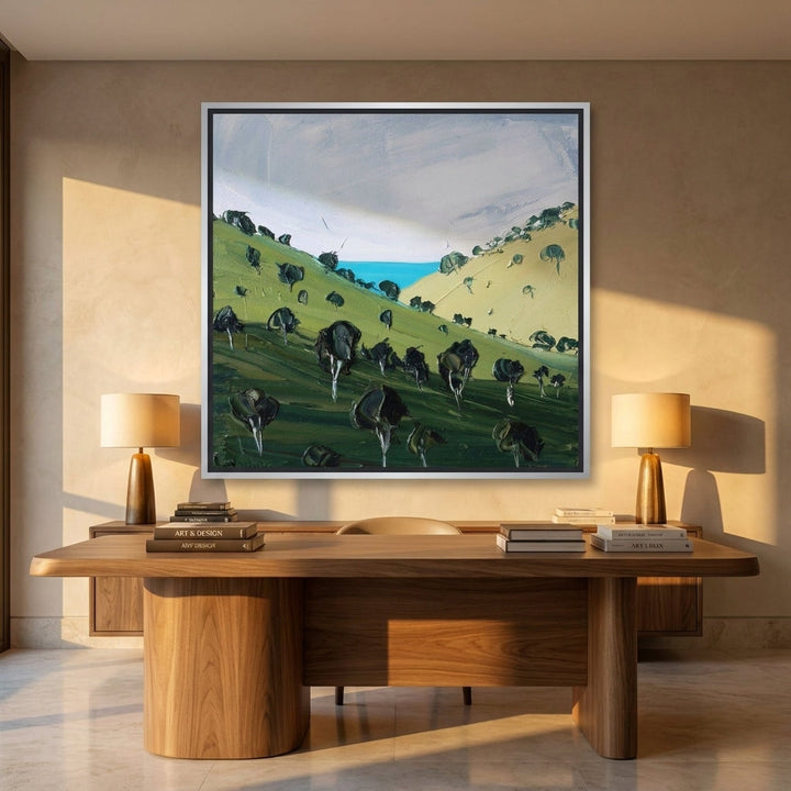 Canvas wall art with a silver leaf surround styled on the wall in a luxe home office