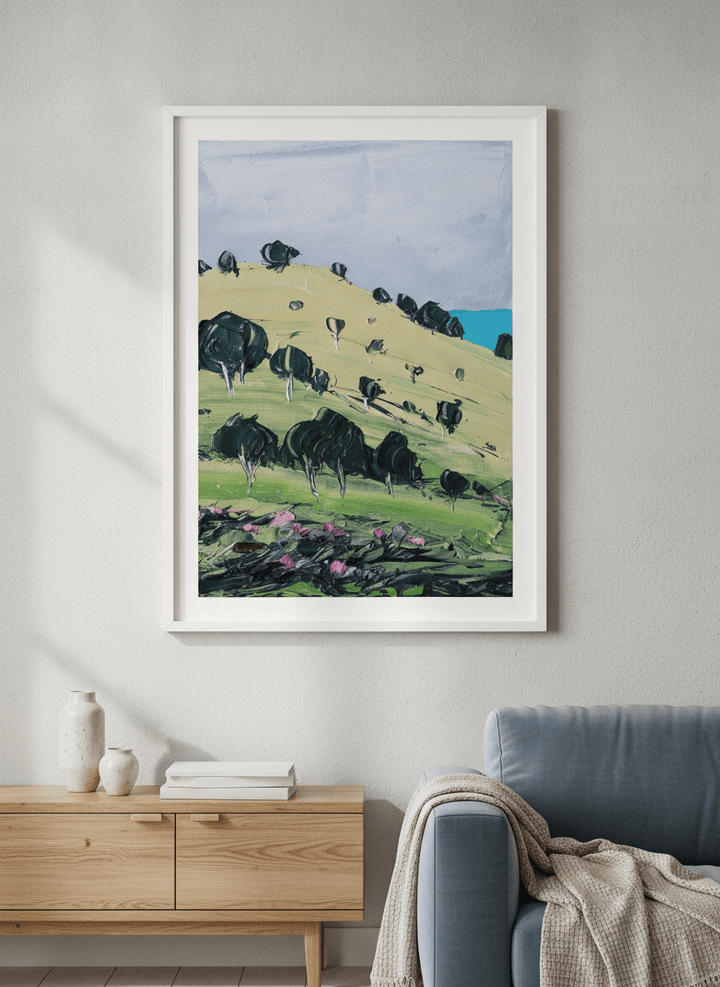 Modern wall art styled above a sofa in a neutral living room