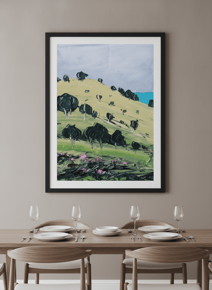 Wall art styled above a dining table in a contemporary home
