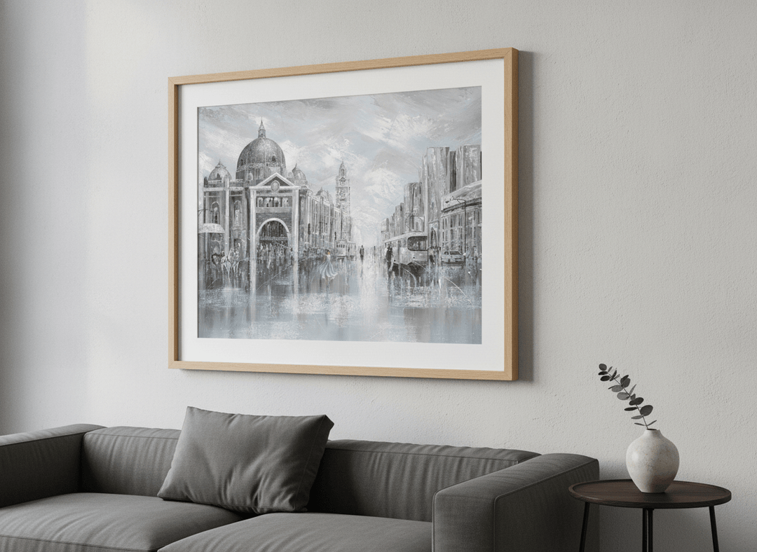 Modern wall art styled above a sofa in a neutral living room