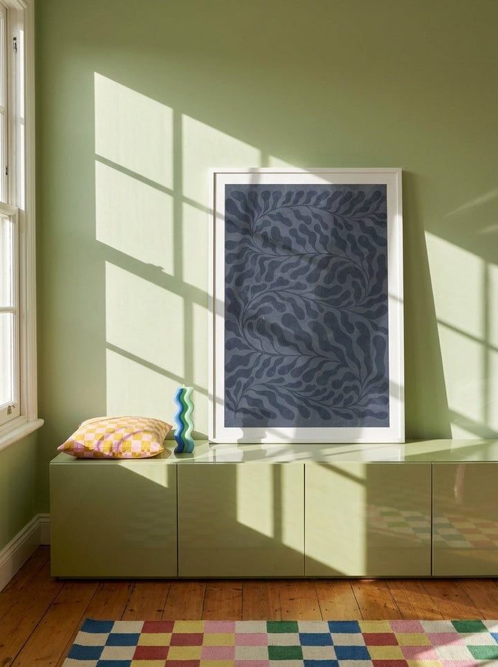 Modern wall art print standing on a sideboard in a colourful eclectic home office