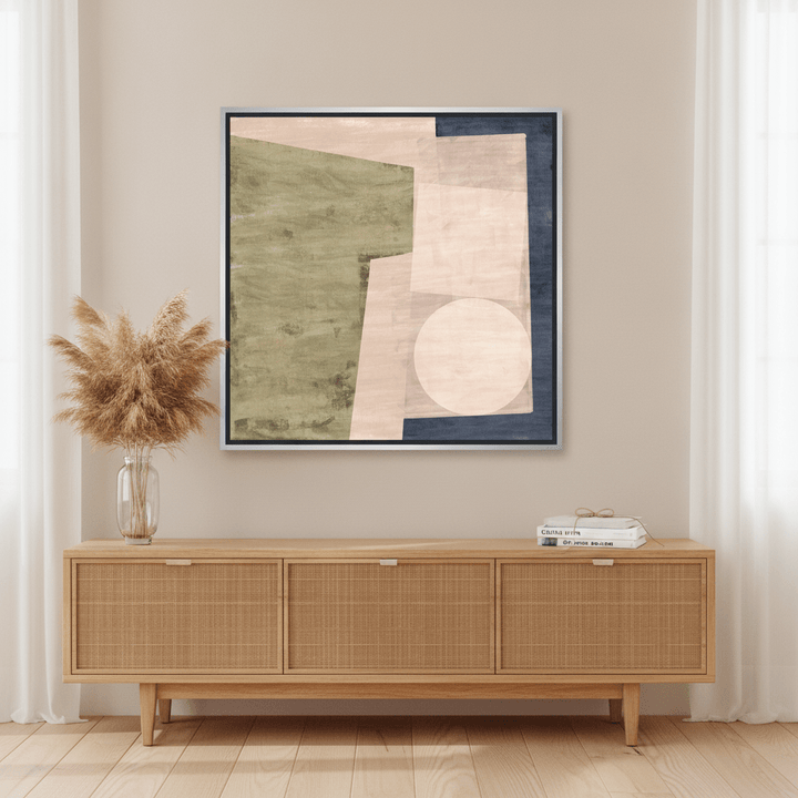 Canvas wall art with a silver leaf surround standing on a sideboard in a coastal home office