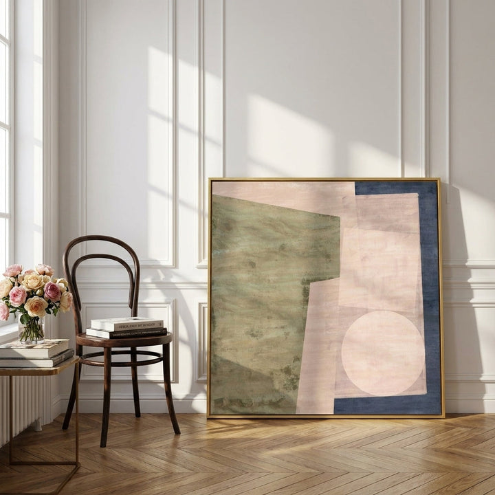 Canvas wall art with a gold leaf surround leaning against the wall in a Parisian bedroom