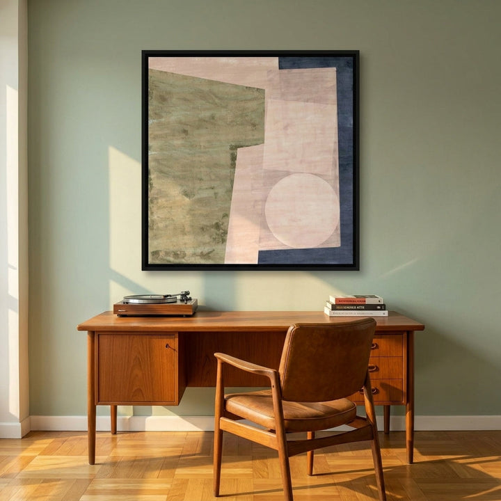 Canvas wall art with a black surround styled on the wall in a mid-century home office