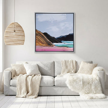 Canvas wall art with a silver leaf surround styled on the wall in a bright Scandinavian living room