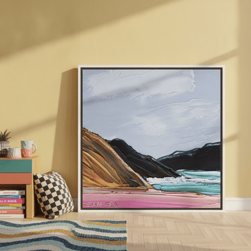 Canvas wall art with a white surround leaning against the wall in a colourful eclectic home office