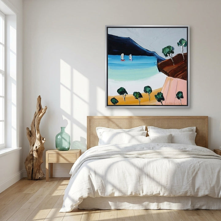 Oversized statement canvas wall art with a silver leaf surround styled on the wall in a coastal bedroom