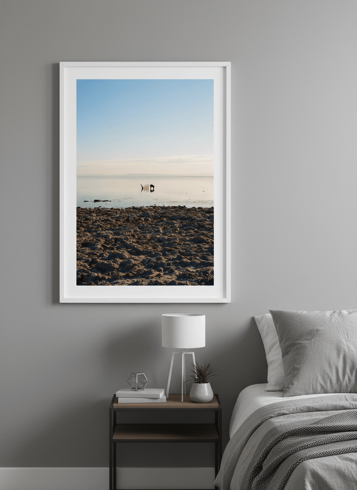 Minimalist artwork displayed in a calm, light-filled bedroom interior