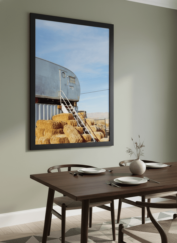 Wall art styled above a dining table in a contemporary home