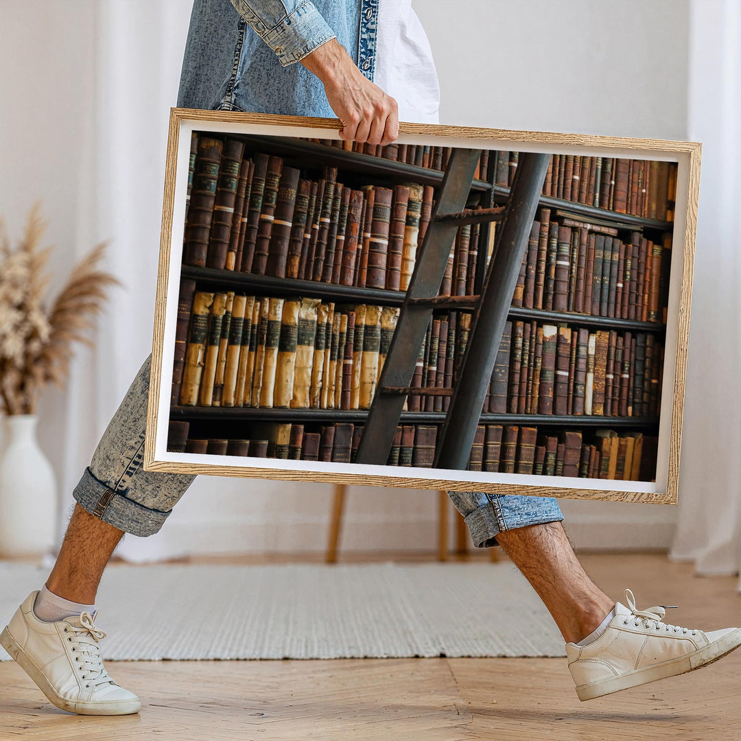 Person holding a picture of a bookshelf with books.
