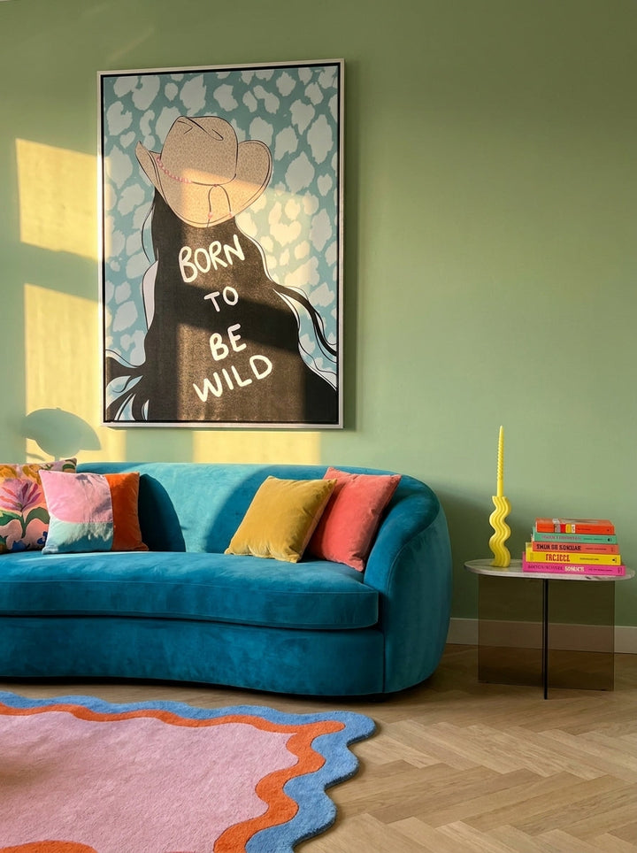 Oversized statement canvas wall art with a silver leaf surround styled on the wall in a colourful eclectic living room