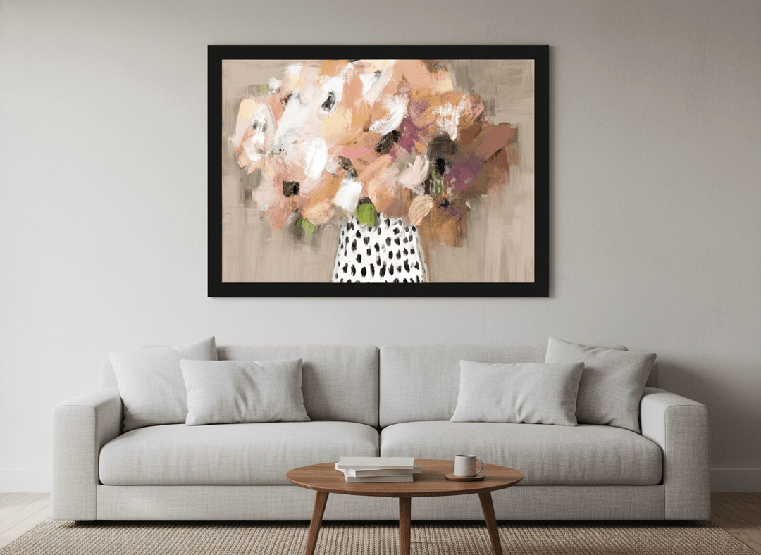 Modern wall art styled above a sofa in a neutral living room