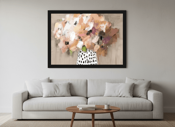Modern wall art styled above a sofa in a neutral living room