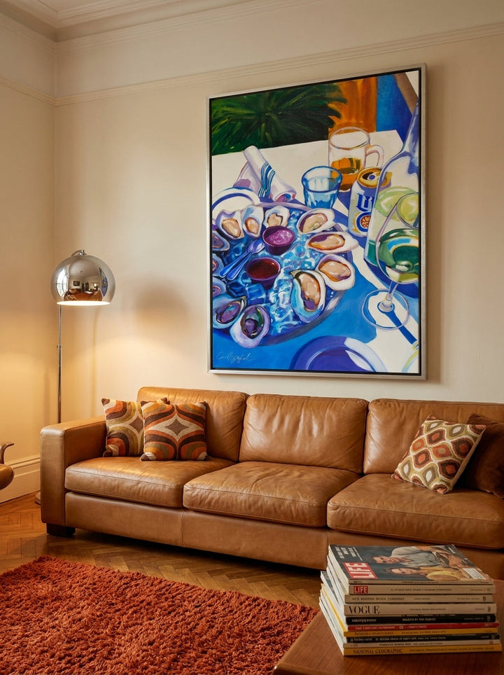 Oversized statement canvas wall art with a silver leaf surround styled on the wall in a retro 70s living room