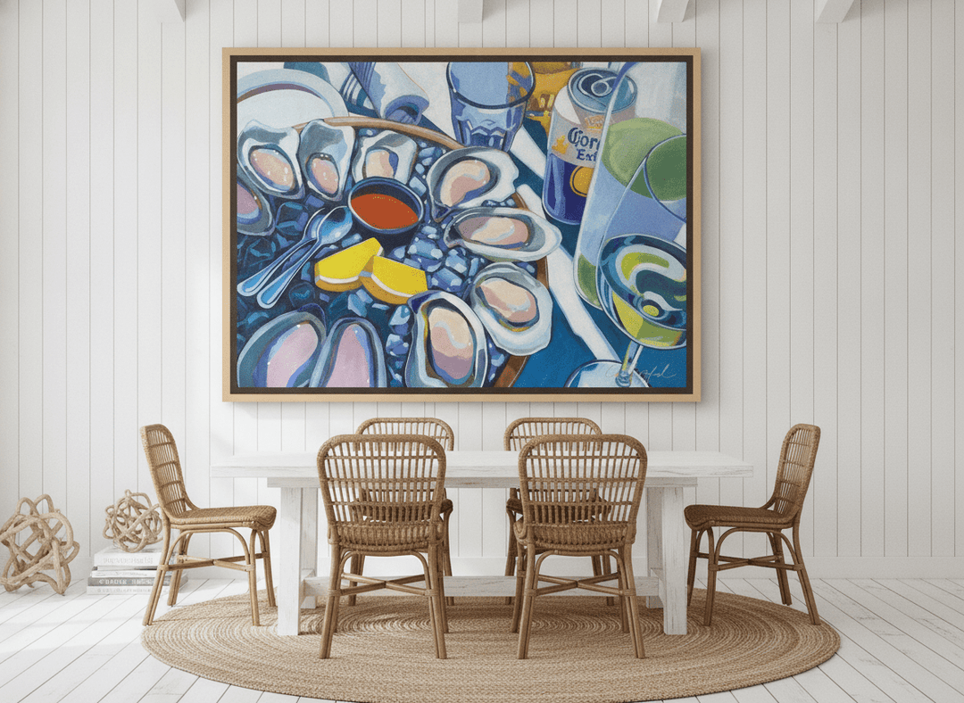Oversized statement canvas wall art with a natural timber surround styled on the wall in a coastal dining room