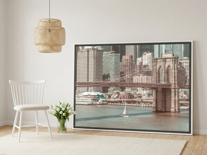 Oversized statement canvas wall art with a white surround leaning against the wall in a bright Scandinavian living room