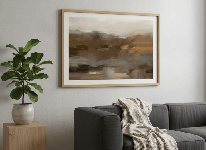 Modern wall art styled above a sofa in a neutral living room