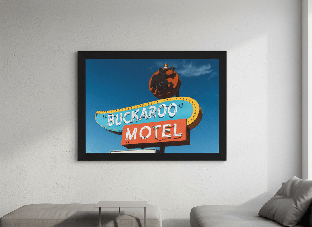 Modern wall art styled above a sofa in a neutral living room