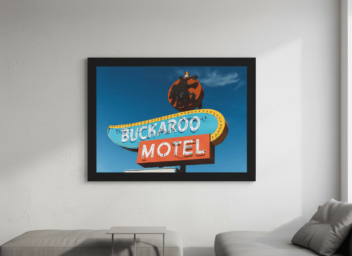 Modern wall art styled above a sofa in a neutral living room