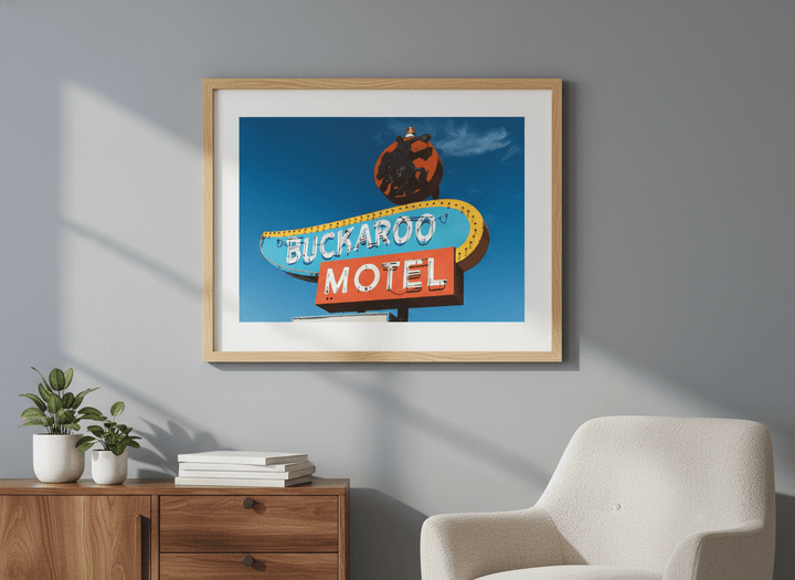 Modern wall art styled above a sofa in a neutral living room