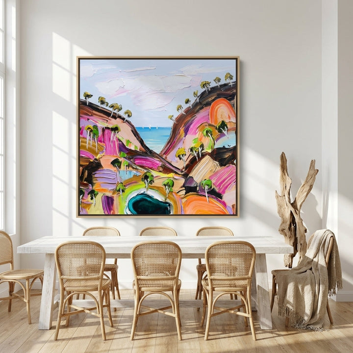 Oversized statement canvas wall art with a natural timber surround styled on the wall in a coastal dining room