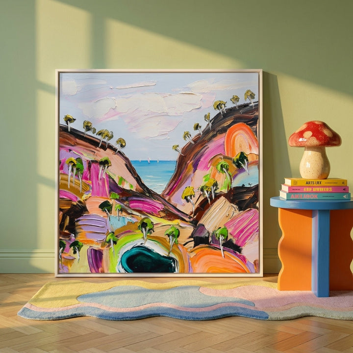 Canvas wall art with a white surround leaning against the wall in a colourful eclectic home office