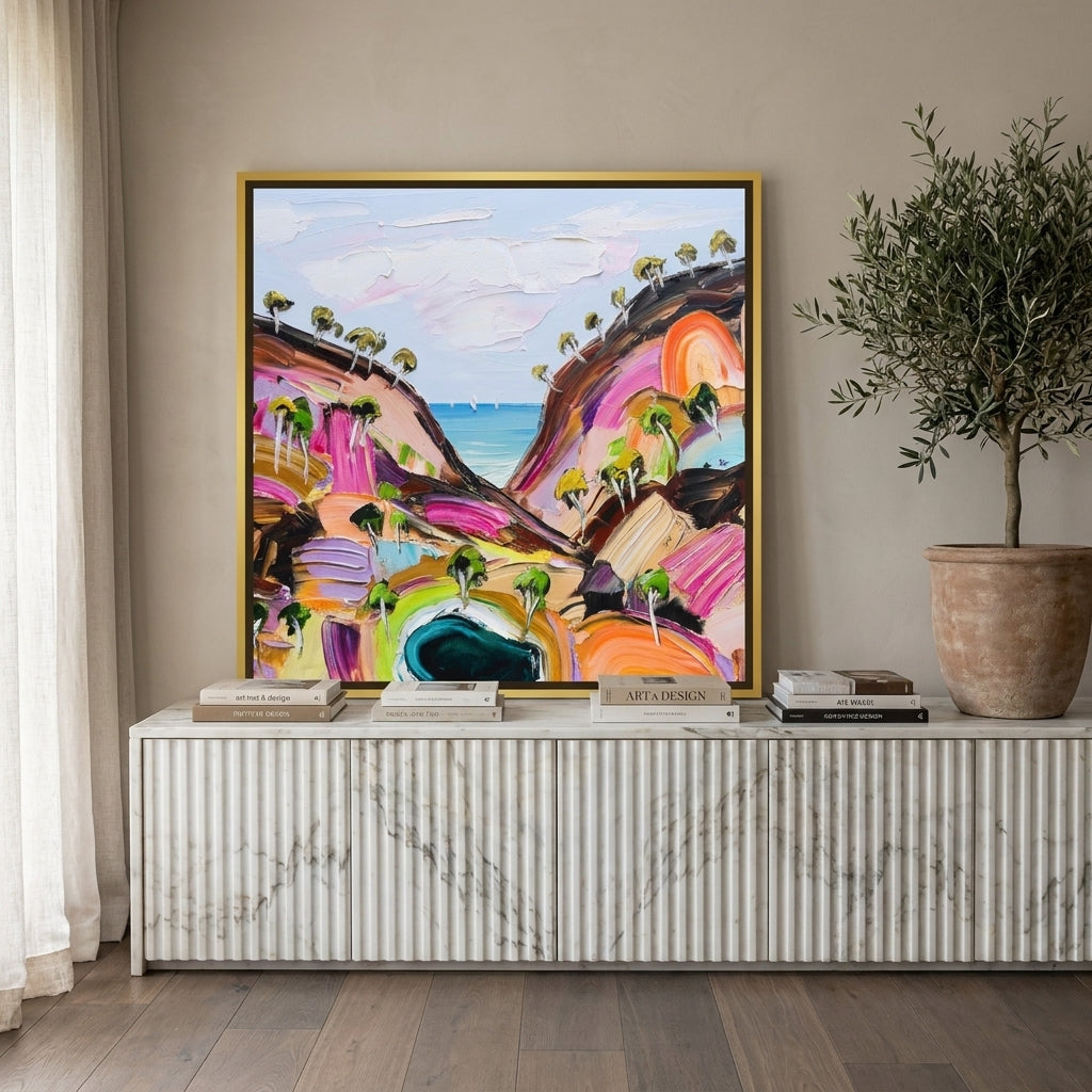 Canvas wall art with a gold leaf surround standing on a sideboard in a luxe bedroom