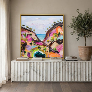 Canvas wall art with a gold leaf surround standing on a sideboard in a luxe bedroom