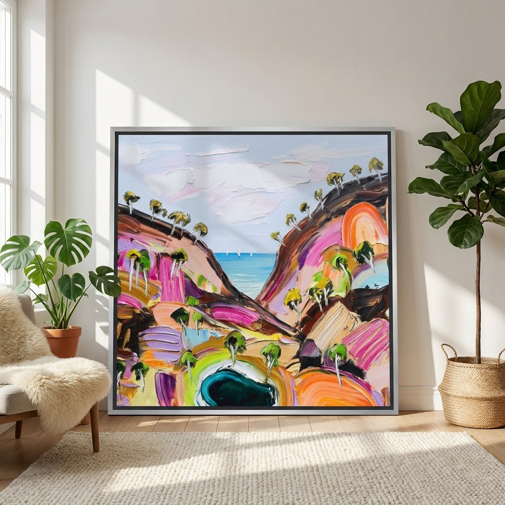 Oversized statement canvas wall art with a silver leaf surround leaning against the wall in a bright Scandinavian living room