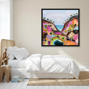 Canvas wall art with a black surround styled on the wall in a coastal bedroom