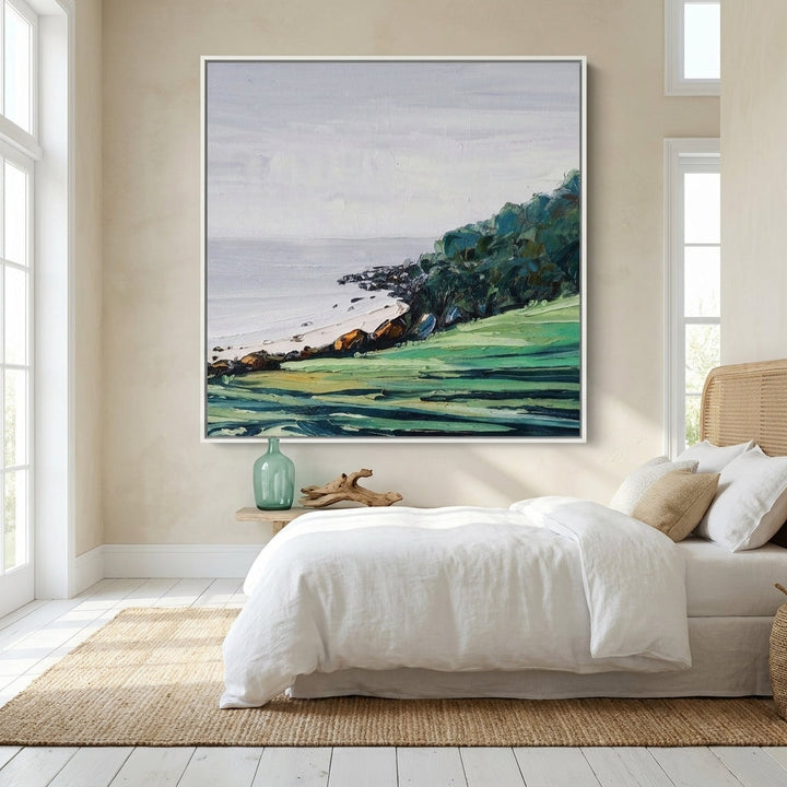 Oversized statement canvas wall art with a white surround styled on the wall in a coastal bedroom