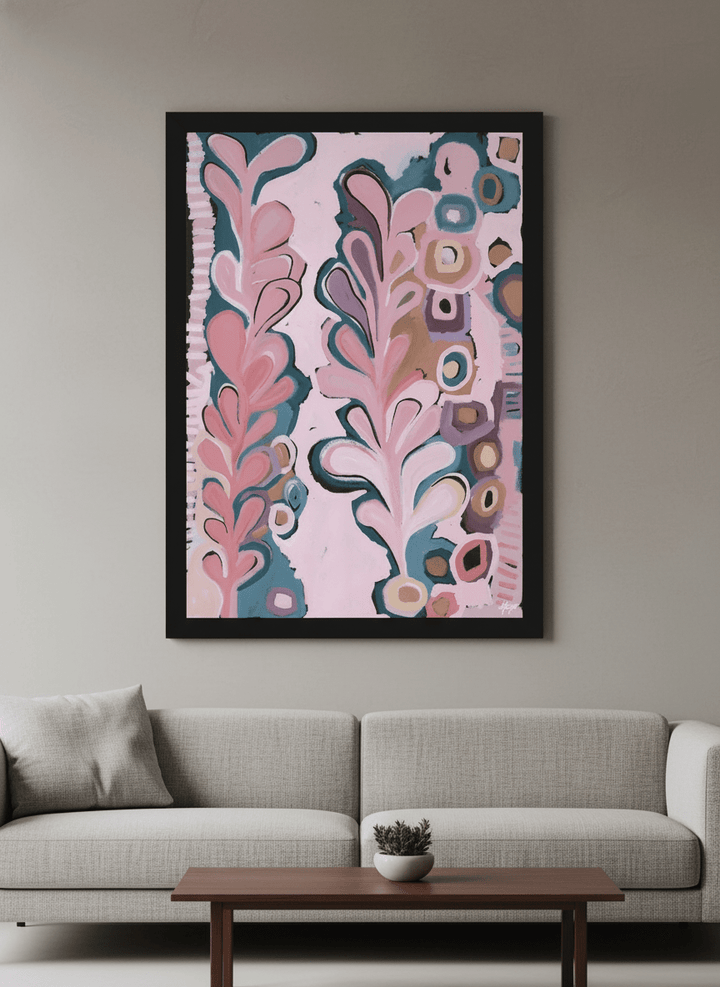 Modern wall art styled above a sofa in a neutral living room