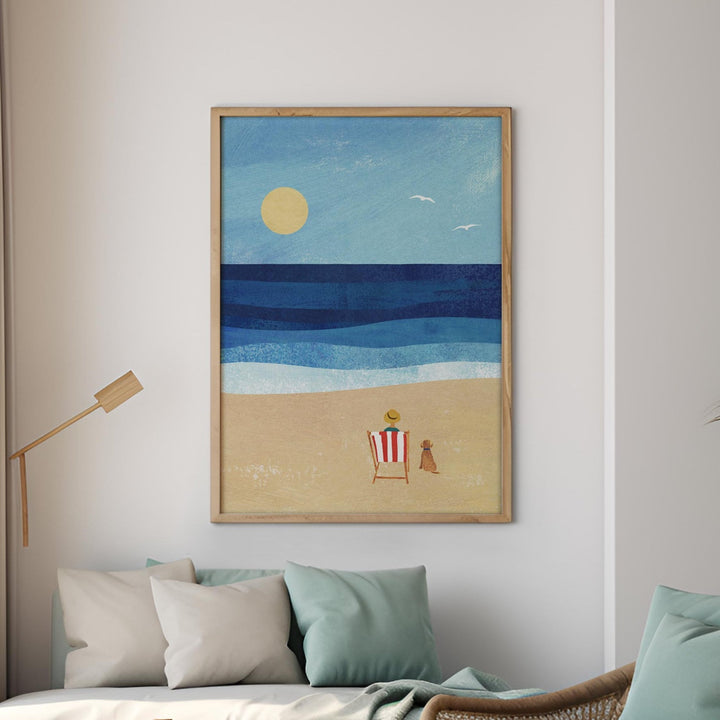 Modern living room with beach-themed decor, including a sofa, armchair, and artwork.