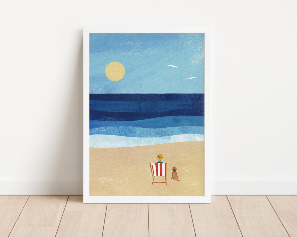 artwork of a beach scene with a sun, ocean, and lounge chair on a white wall.