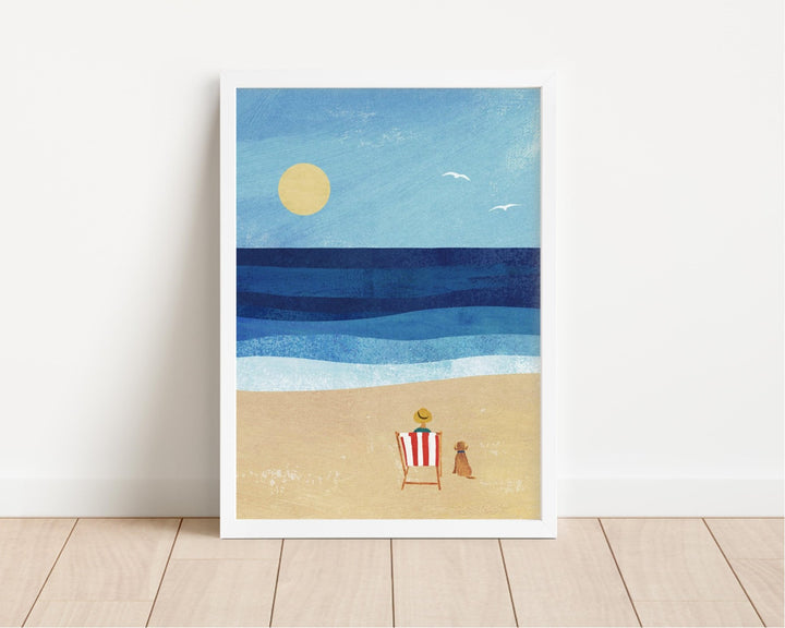 artwork of a beach scene with a sun, ocean, and lounge chair on a white wall.