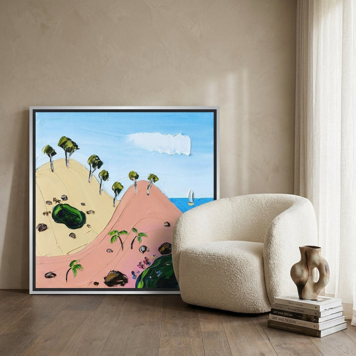 Canvas wall art with a silver leaf surround leaning against the wall in a luxe home office