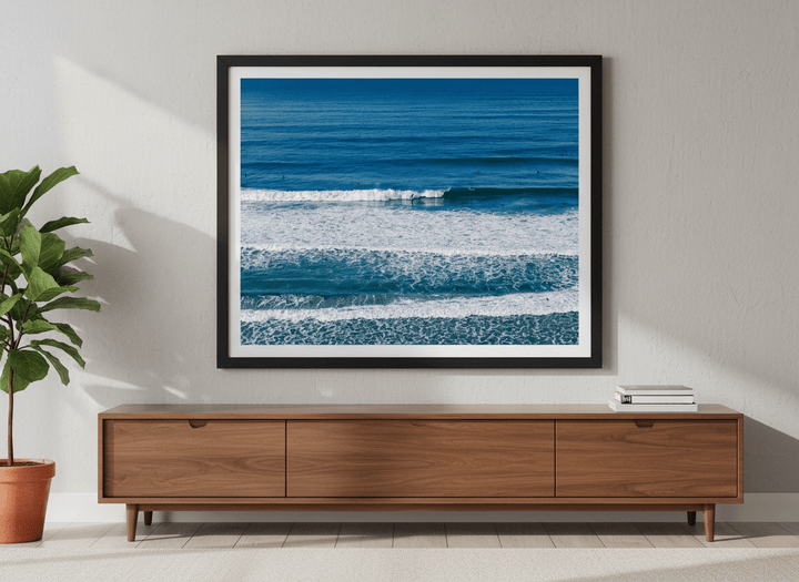 Modern wall art styled above a sofa in a neutral living room