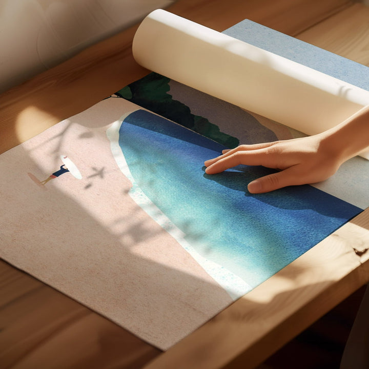 Person rolling out a large mat with a scenic design on a wooden floor.