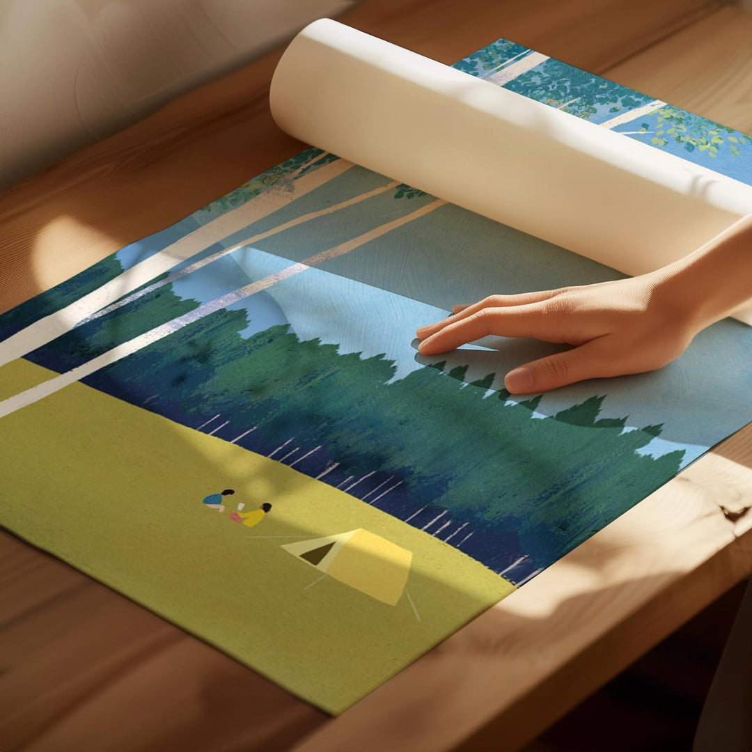 Person rolling out a scenic placemat with nature design on a wooden surface