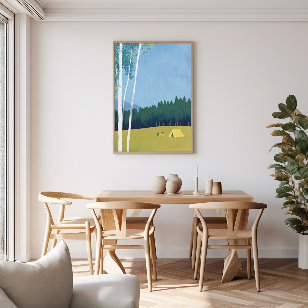 Dining room with wooden table and chairs, artwork on the wall, and a plant.