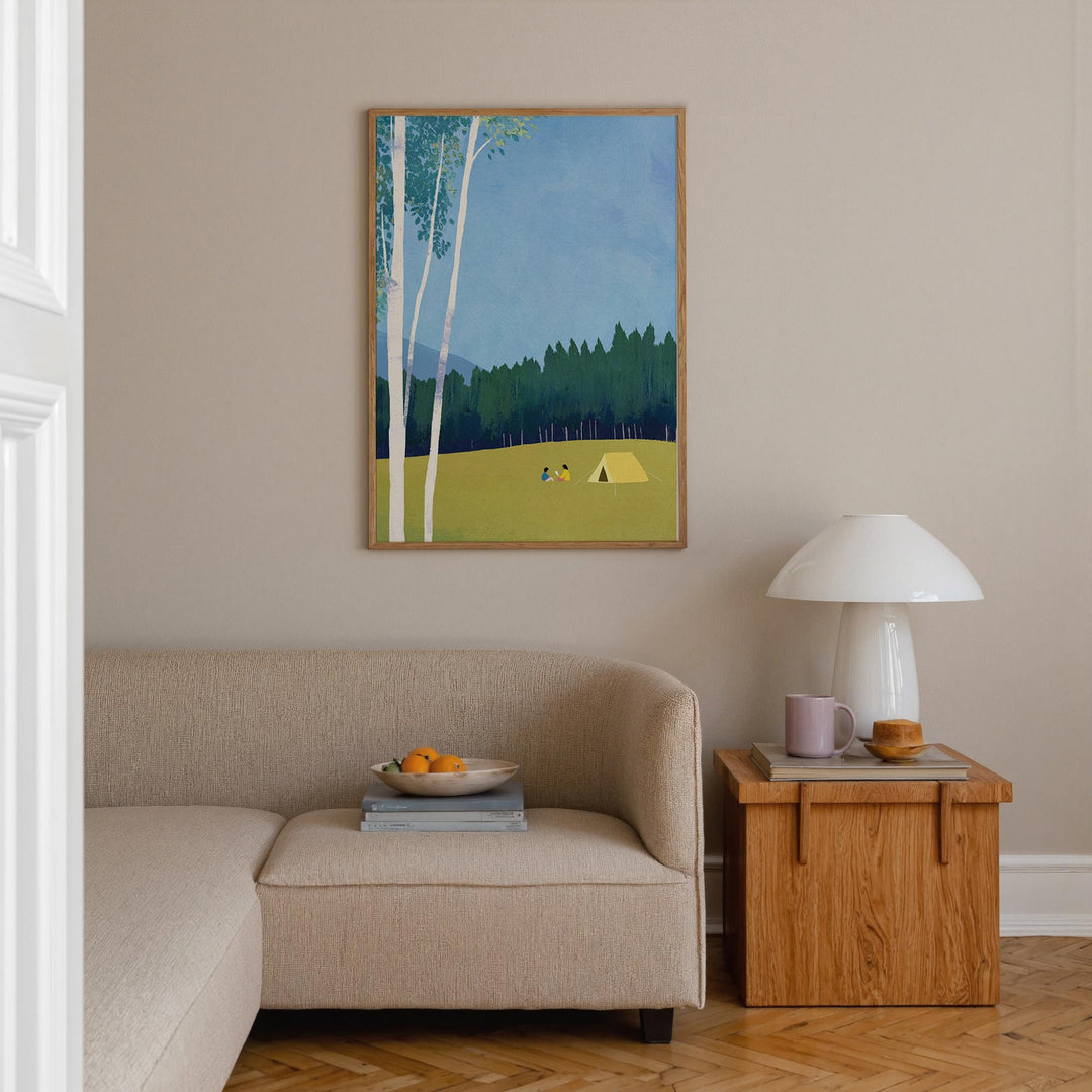 Living room with beige sofa, wooden side table, and an artwork of a forest scene.