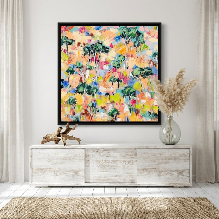 Canvas wall art with a black surround standing on a console in a coastal bedroom