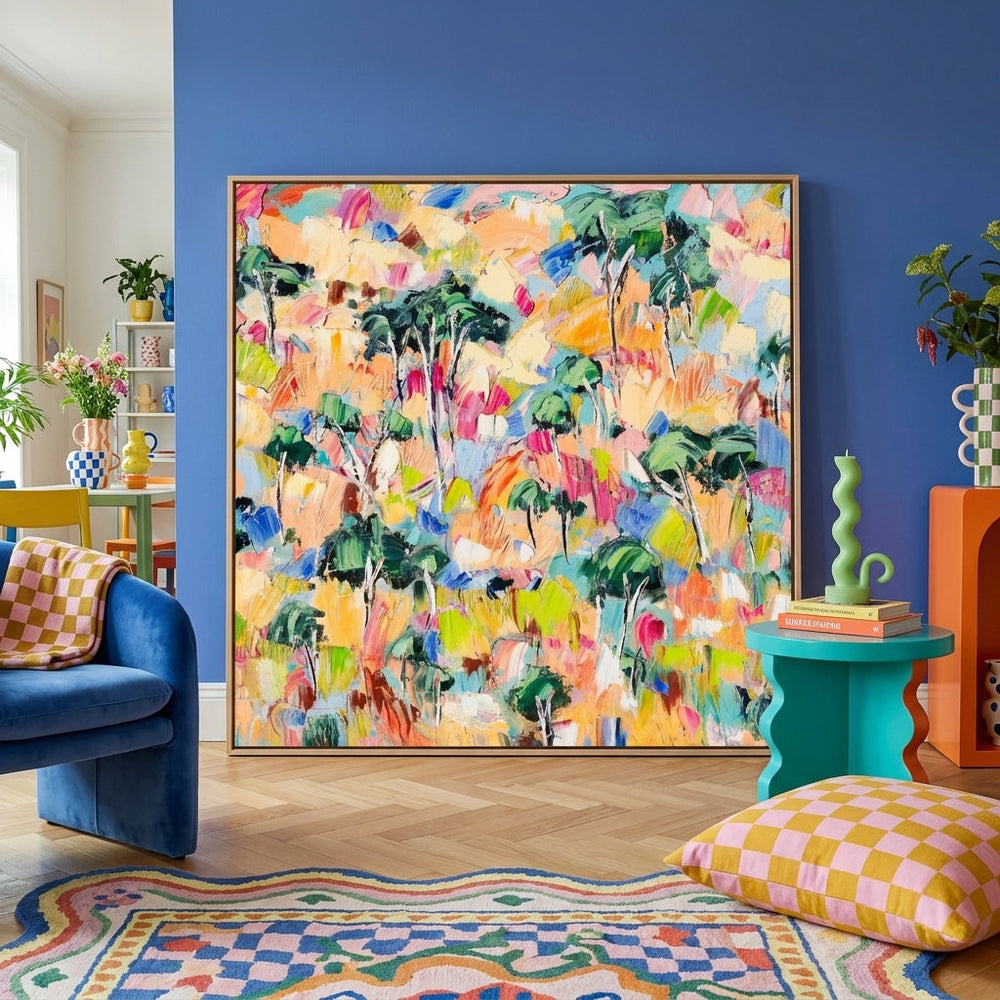 Oversized statement canvas wall art with a natural timber surround leaning against the wall in a colourful eclectic dining room