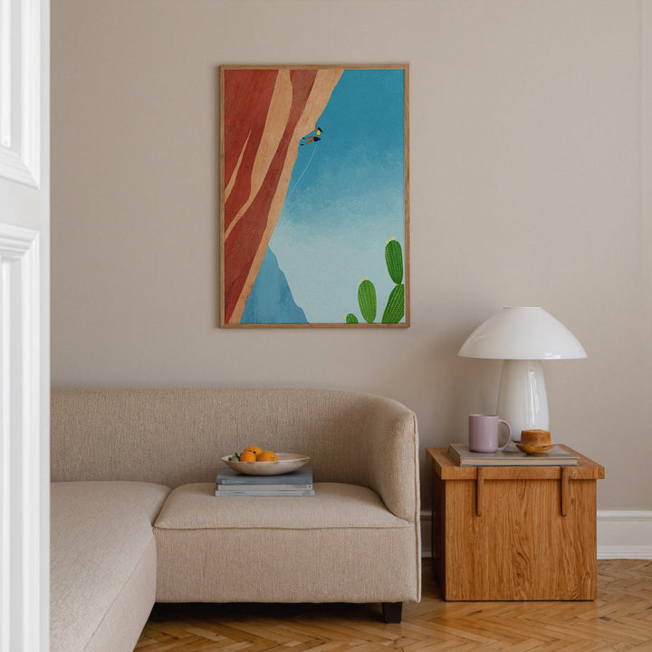 Living with sofa, side table with lamp and artwork hanging on the wall