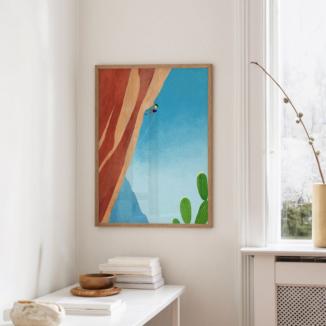 artwork hanged on wall with books on table