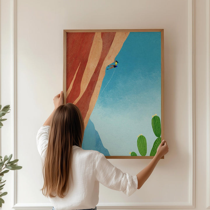 Girl holding artwork on wall