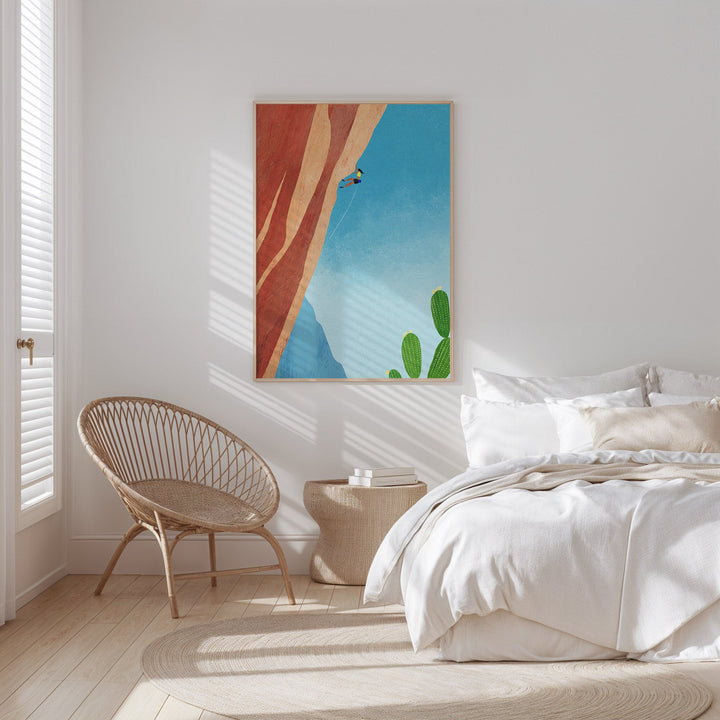 white bedroom with chair and artwork hanging on the wall
